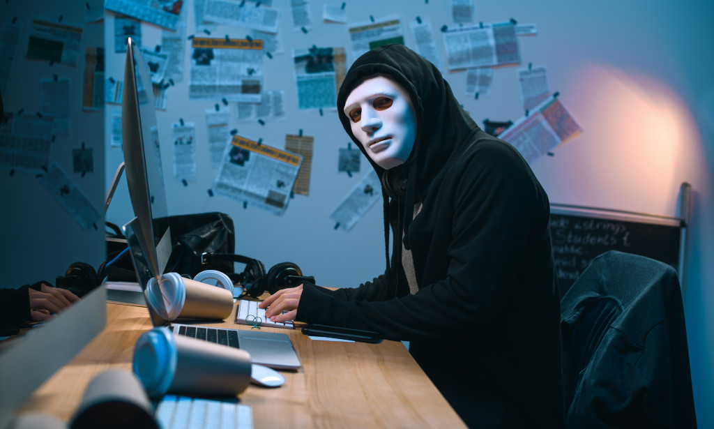 1616765951 hacker in mask developing malware at his workplace 397g6tt